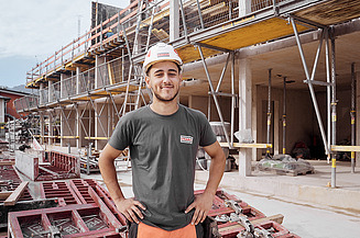 Zwei Männer mit Helm auf einer Baustelle